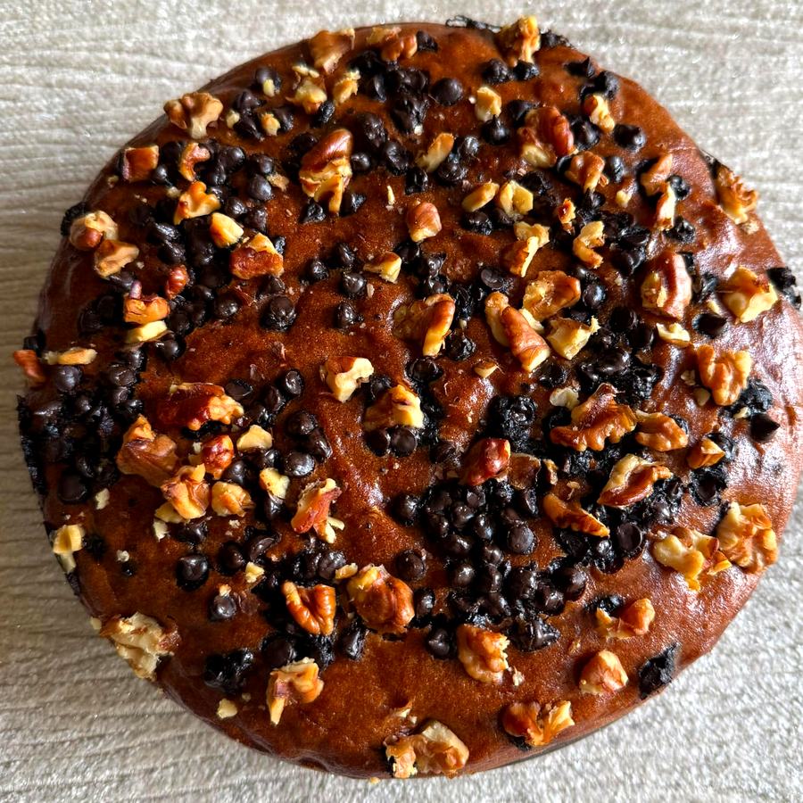 Whole wheat banana chocolate chip walnut cake topped with walnuts